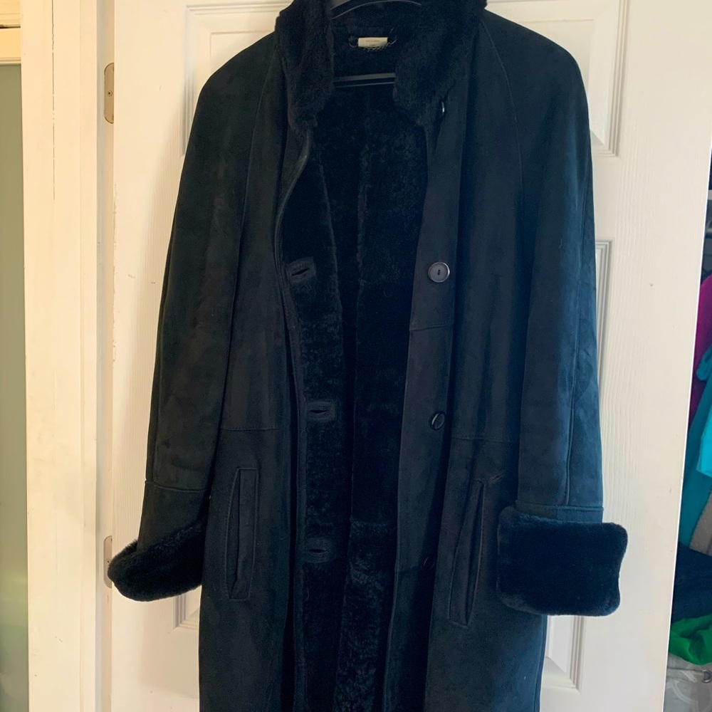 Elegance suede shearling swing coat with fur trim.